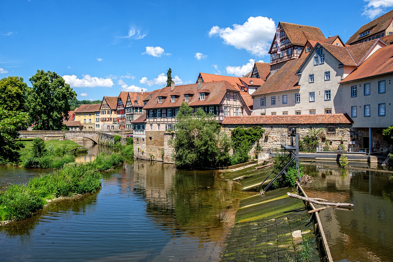 a river running through a town next to tall buildings, a picture, by Juergen von Huendeberg, shutterstock, renaissance, nuremberg, huge suspended wooden bridge, wide panoramic shot, summer day