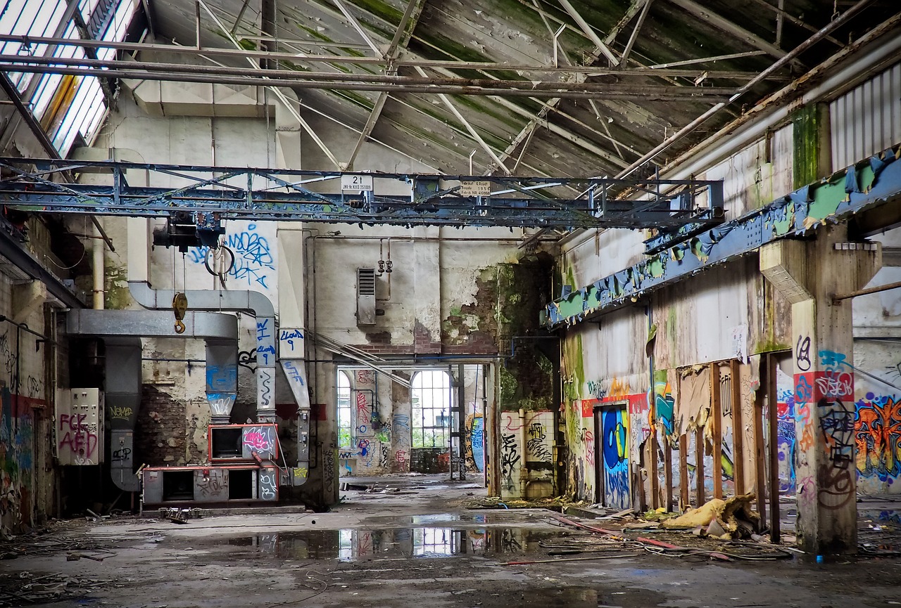 a building with lots of graffiti on the walls, by Richard Carline, flickr, urbex photography, maintenance area, leaking, standing still