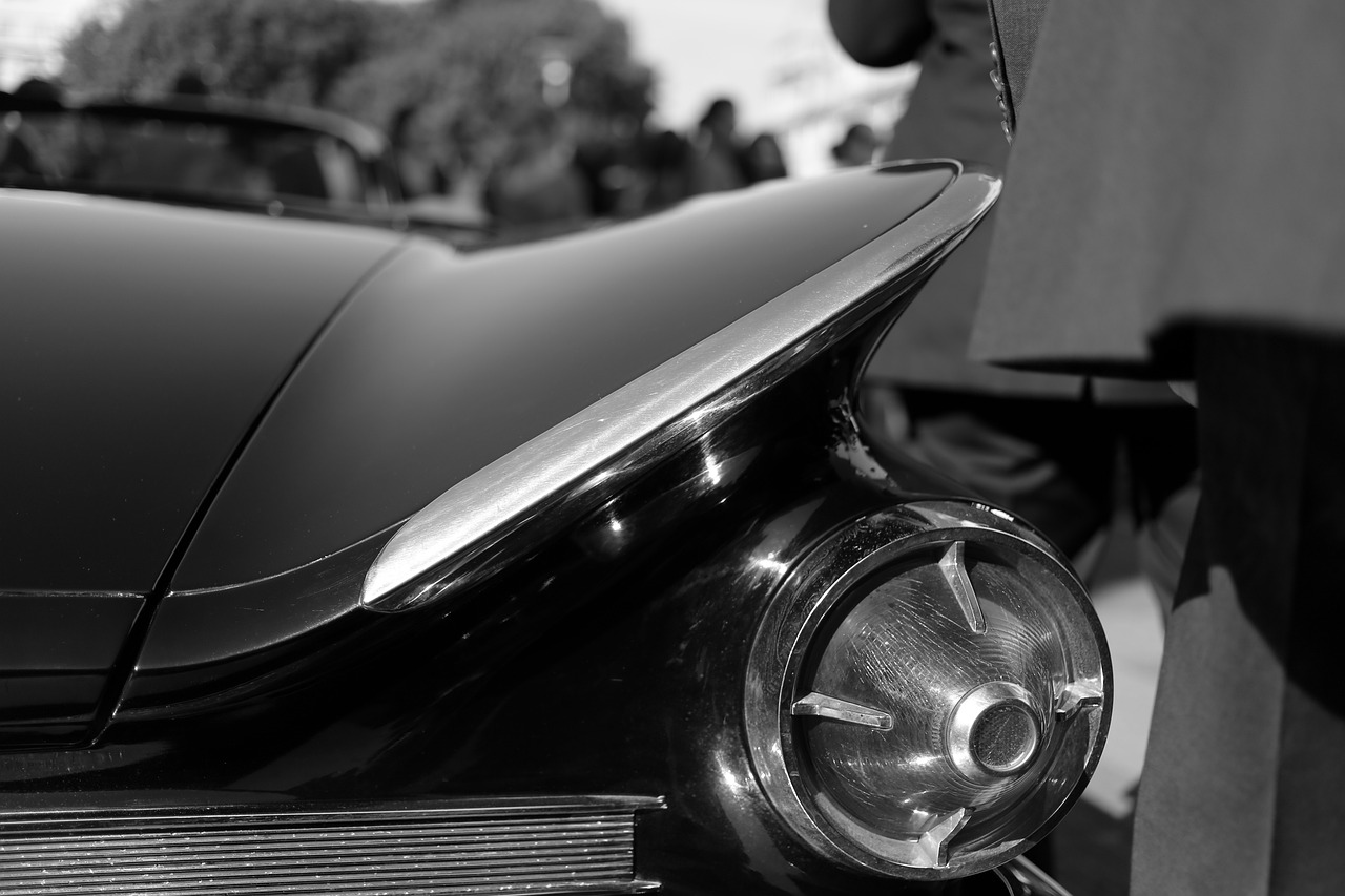 a black and white photo of a classic car, a black and white photo, by Sven Erixson, fineline detail, sleek metal head, batmobile, chromed metal