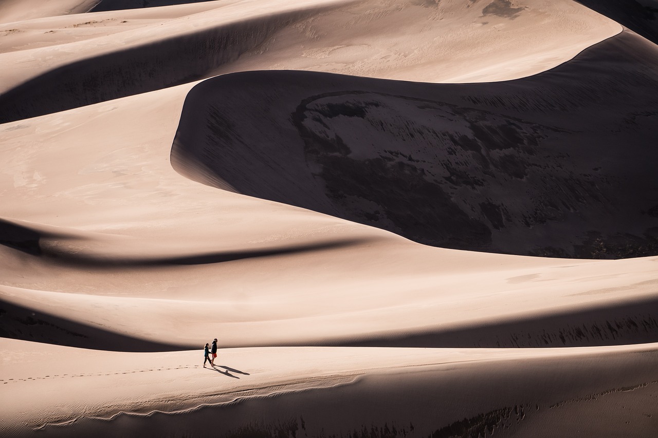 a couple of people that are walking in the sand, by Matthias Weischer, canyons, grand, peaks, f / 2 0