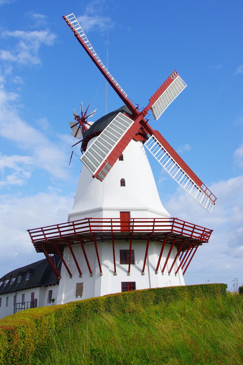a windmill sitting on top of a lush green hillside, a picture, inspired by Robert Zünd, white and red color scheme, detmold charles maurice, celebration, interesting details