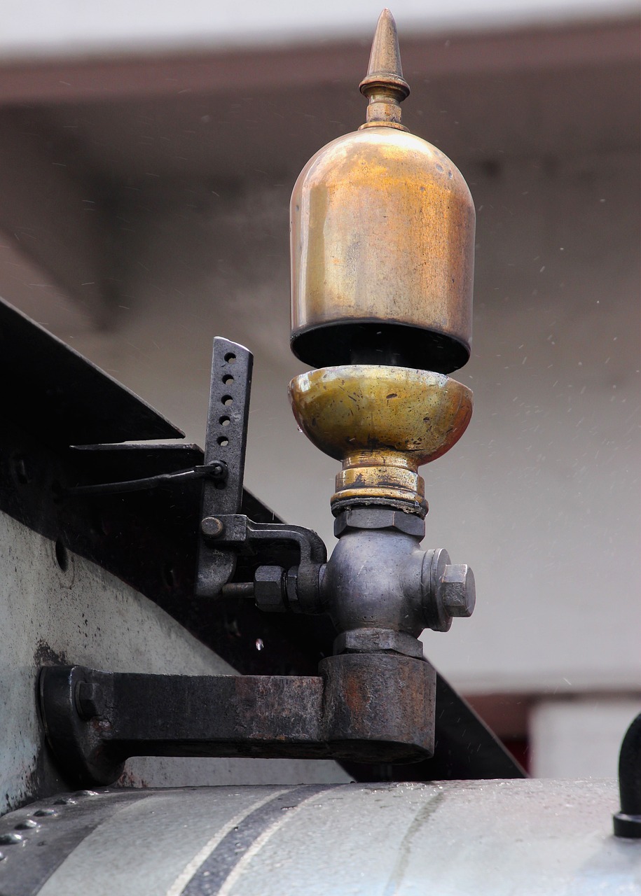 a close up of a fire hydrant on the side of a building, by David Garner, flickr, assemblage, brass and steam technology, boat with lamp, steam train, bangalore