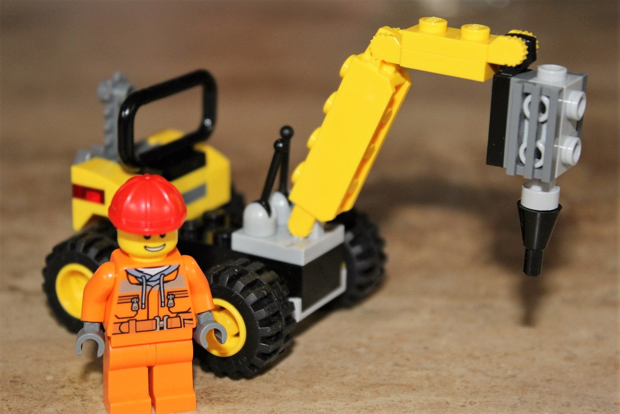 a lego man standing next to a construction vehicle, a picture, inspired by Lydia Field Emmet, (sfw) safe for work, 🦩🪐🐞👩🏻🦳, closeup - view, ready to model