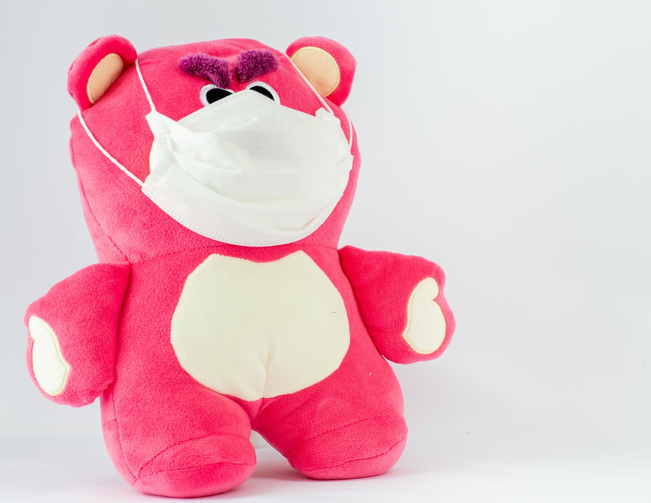 a pink teddy bear wearing a face mask, a photo, high res photo