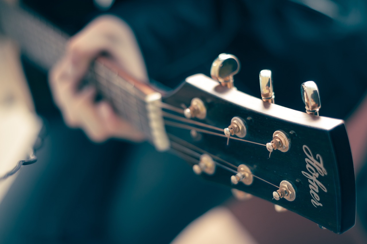 a close up of a person playing a guitar, a picture, shutterstock, head and shoulder shot, high details photo, stock photo