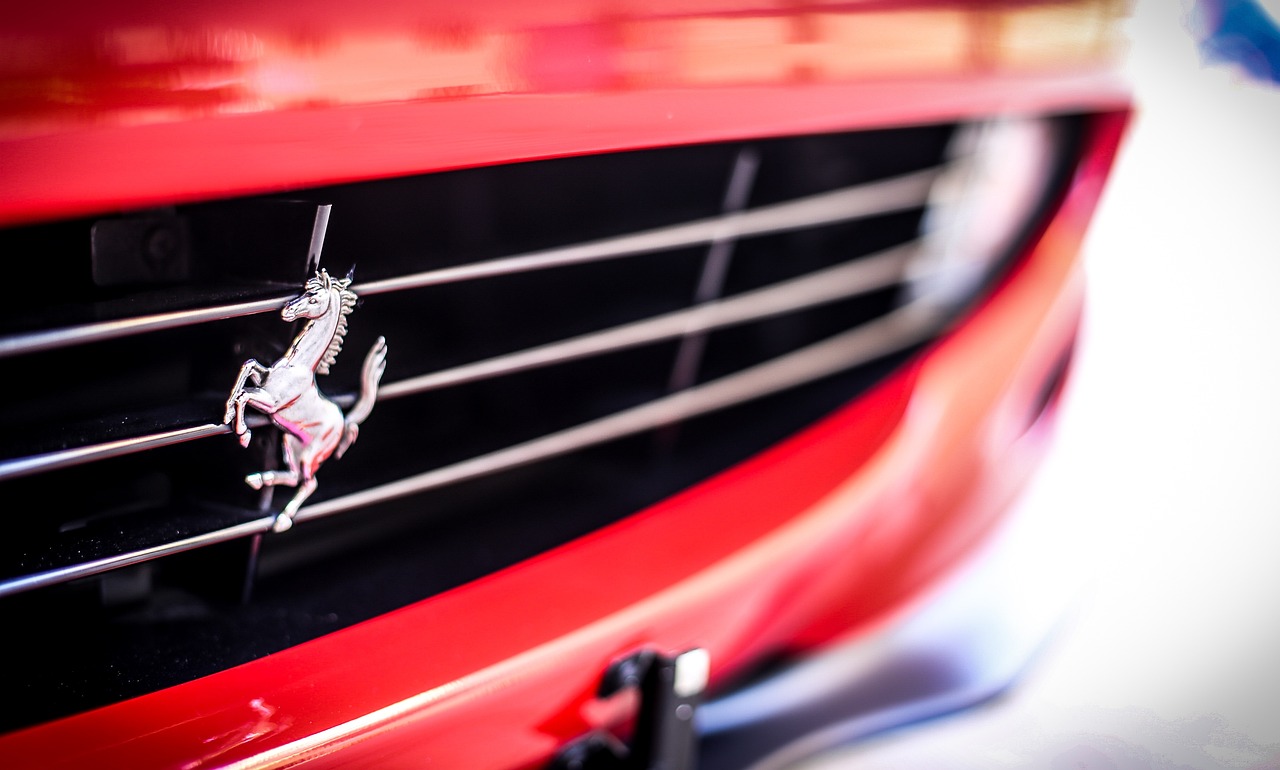a close up of a horse on the front of a red car, inspired by Bernardo Cavallino, unsplash, chest plate with ferrari logo, 8k 50mm iso 10, glossy surface, taken with sony alpha 9
