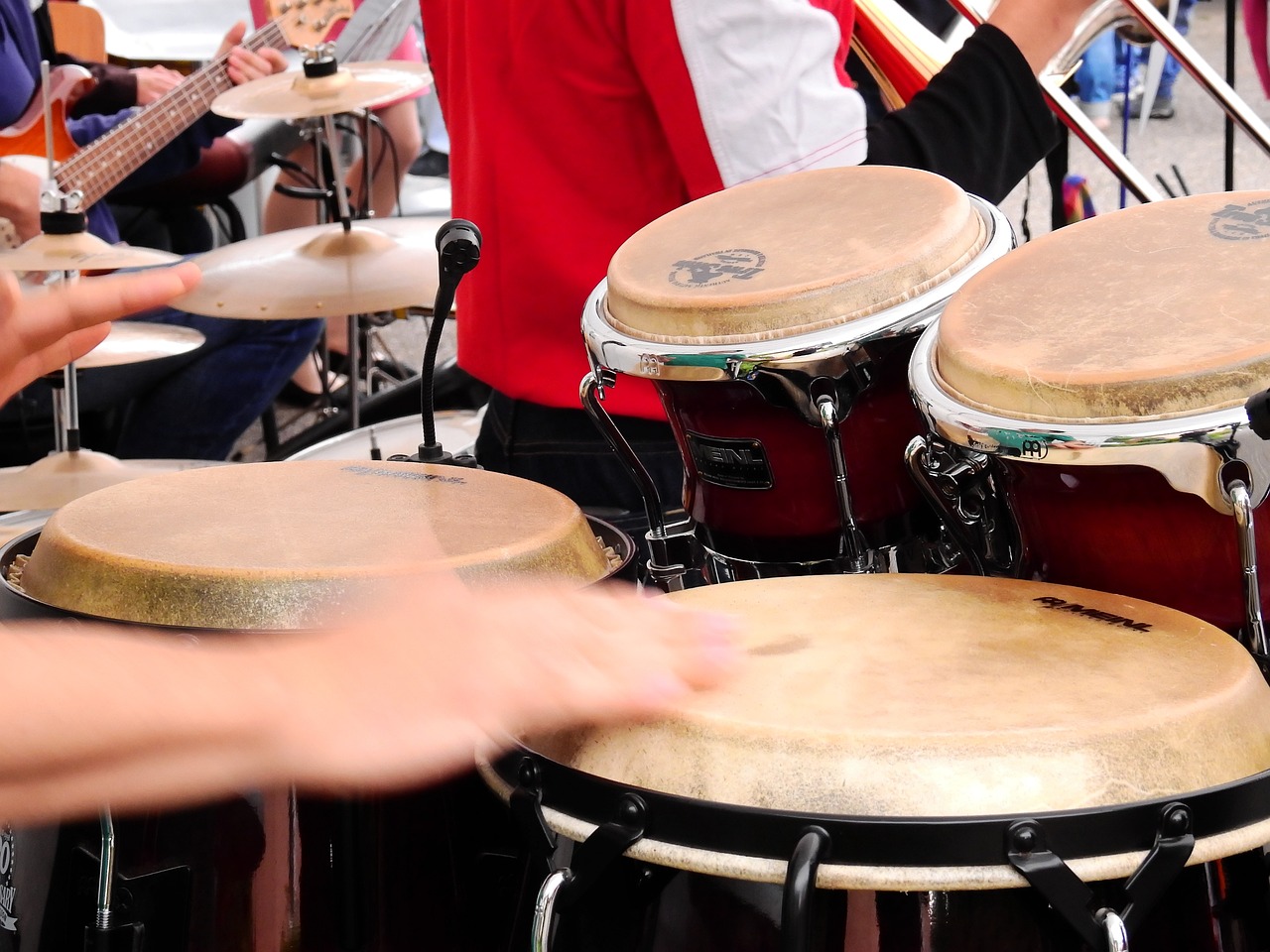 a group of people that are playing drums, by Juan O'Gorman, shutterstock, white sleeves, tamborine, panoramic, plan