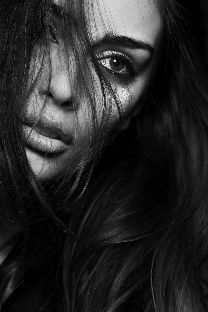 a black and white photo of a woman with long hair, featured on cgsociety, extreme close up face shot, lips, hiding, portrait of sherlyn chopra