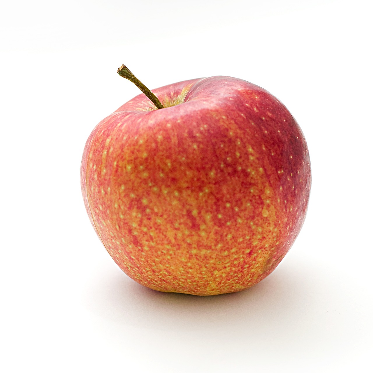 a red apple sitting on top of a white surface, renaissance, istockphoto, abundant detail, full color, vga