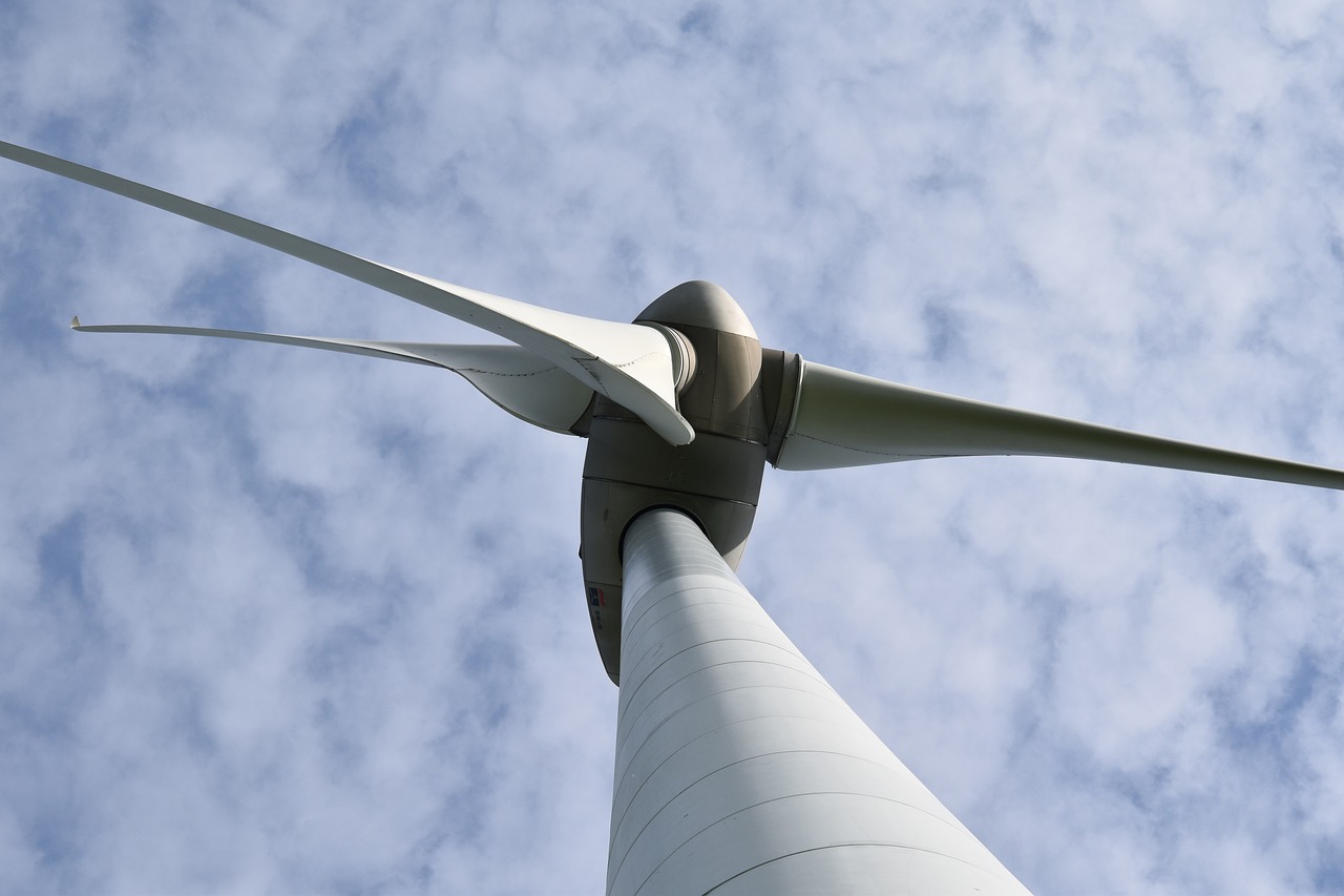 a close up of a wind turbine on a cloudy day, a screenshot, pixabay, perspective from below, in 2 0 1 2, benjamin vnuk, profile close-up view