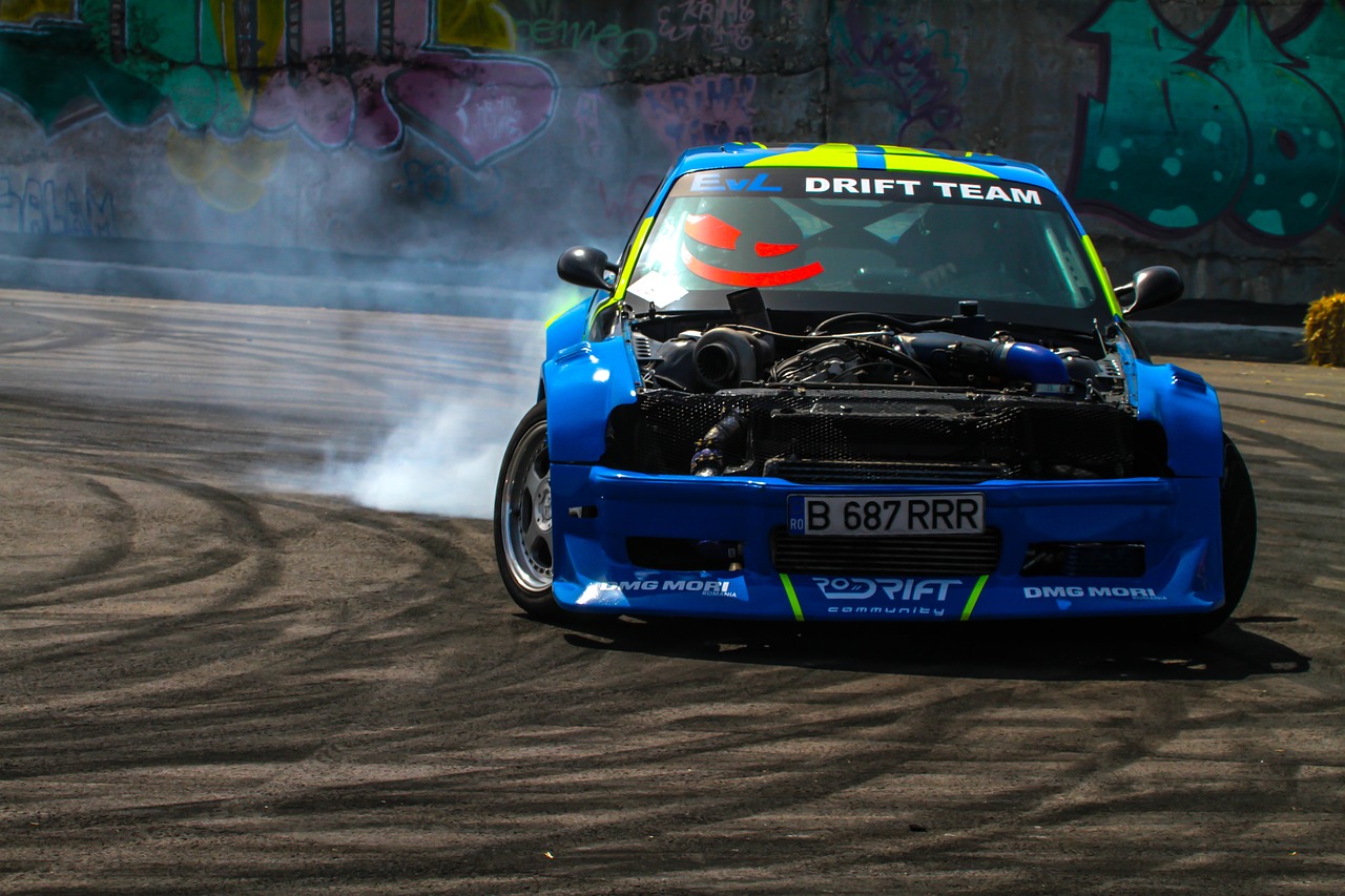 a blue car with a bunch of smoke coming out of it, inspired by Sam Dillemans, shutterstock, graffiti, crazy racer spinning, donut, extreme wide shot, pillar