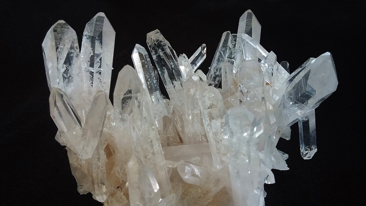 a cluster of crystals sitting on top of a black surface, by Lee Loughridge, in a beautiful crystal caverine, white, close up high detailed, 4 0 9 6