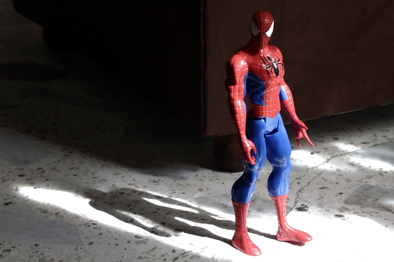 a close up of a toy spider - man on a floor, photorealism, standing in a dimly lit room, acton figure, comic character, full body profile