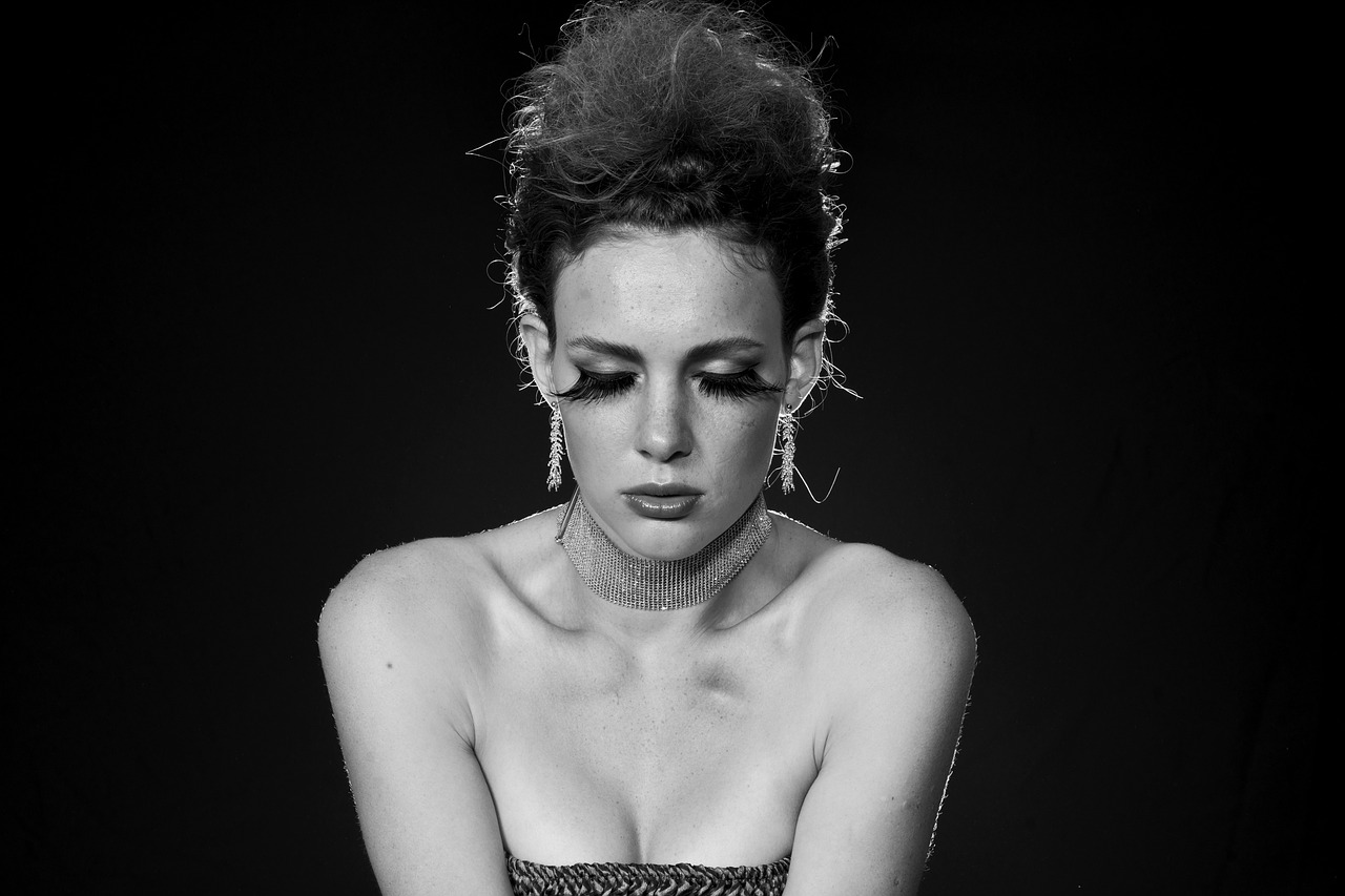 a black and white photo of a woman in a dress, a black and white photo, inspired by Bert Stern, flickr, bauhaus, crying makeup, kate beckinsale, 8 0's hairstyle, devon cady-lee