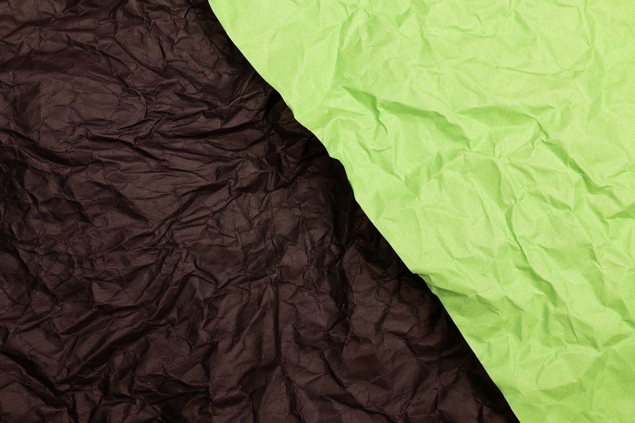 a green and black sheet of paper next to each other, shutterstock, paper crumpled texture, packshot, closeup photo, sleeping bag
