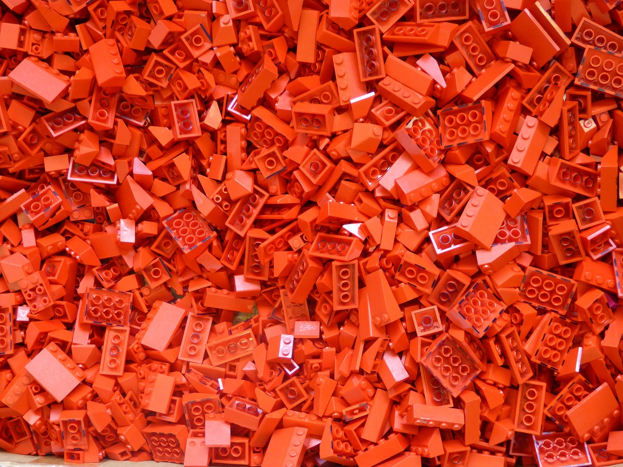 a pile of red lego bricks sitting on top of a table, by Lee Loughridge, plasticien, vibrant but dreary orange, photograph credit: ap, buildings covered with greebles, hd —h 1024