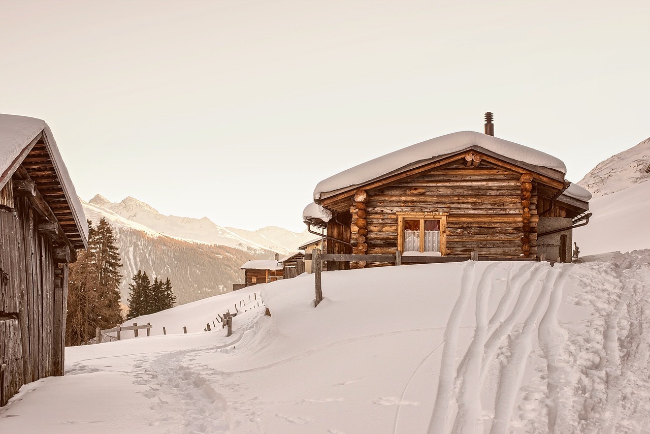 a cabin sitting on top of a snow covered slope, by Matthias Weischer, pexels, renaissance, late afternoon, conde nast traveler photo, high quality upload, heaven on earth