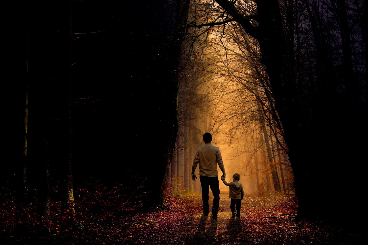 a man and a child walking down a path in the woods, a picture, by Eugeniusz Zak, pexels, conceptual art, golden glow, dark bg, mom, remembering his life