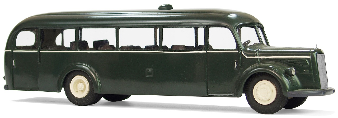 a green toy bus sitting on top of a white surface, by Bob Ringwood, flickr, fine art, 1 9 4 4, clear detailed view, section model, ebony