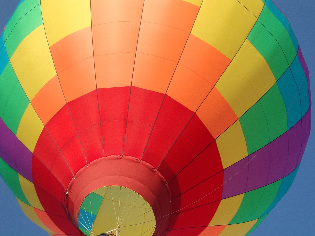 a colorful hot air balloon flying in the sky, by Jan Rustem, color field, insanely inflated hips, inside a globe, full of colour w 1024, mid closeup