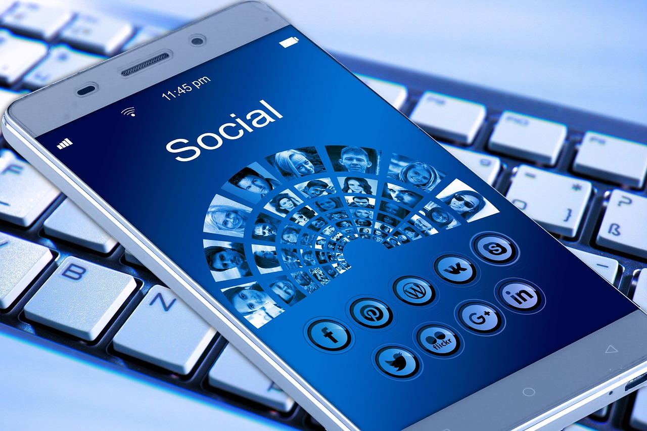 a cell phone sitting on top of a keyboard, a digital rendering, by Arthur Sarkissian, shutterstock, logo for a social network, blue theme, marketing photo, is a stunning