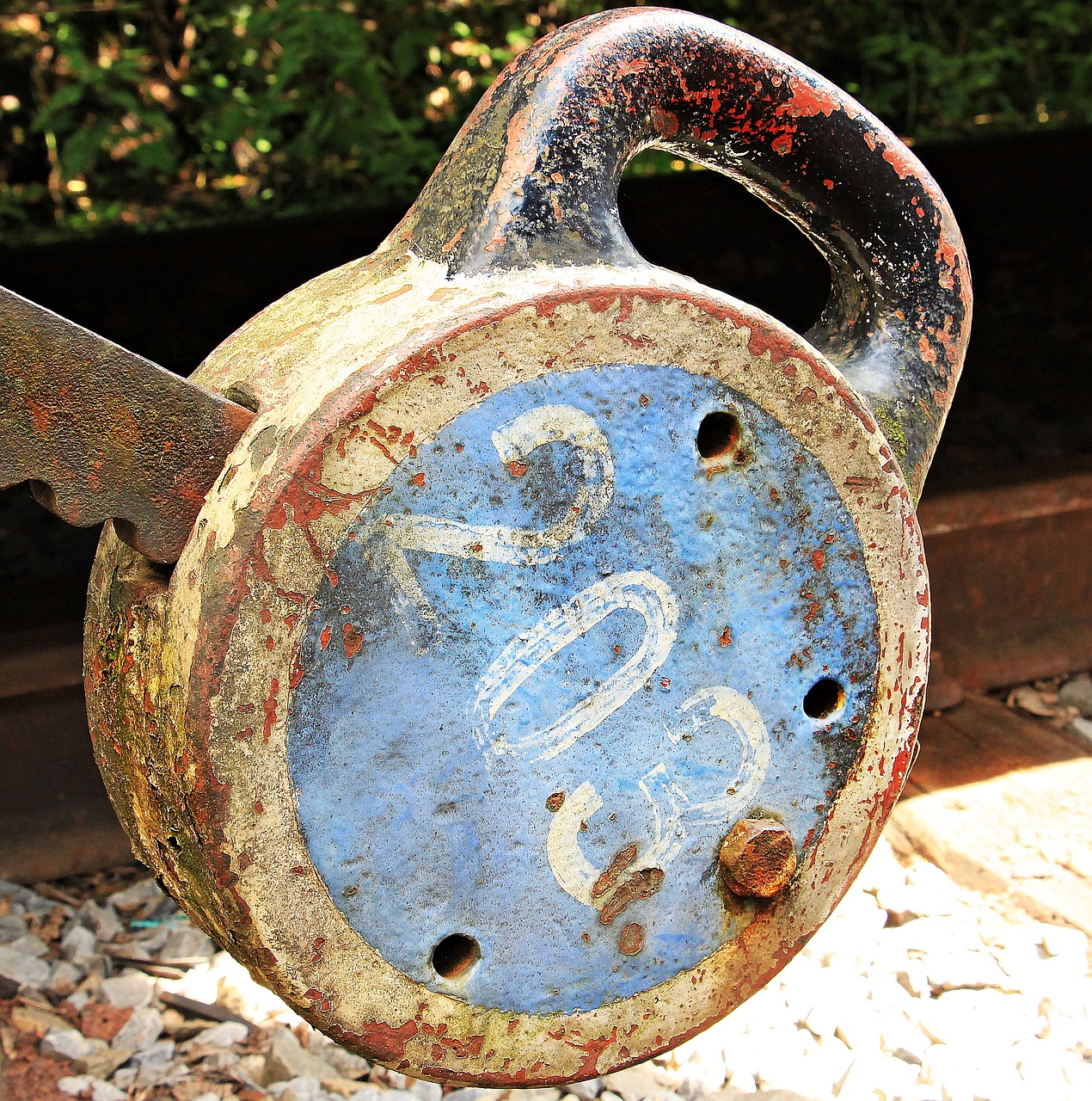 a close up of a metal object on a train track, by Richard Carline, flickr, key hole on blue ball, saws, # 2 2 3 3 e 6, old signs