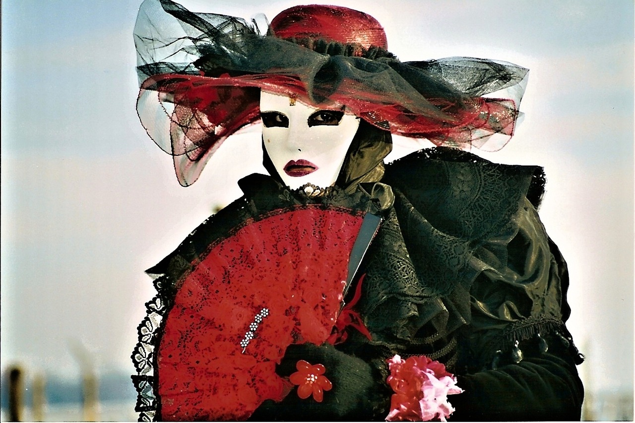 a woman wearing a mask and holding a red fan, a photo, inspired by Jean Jouvenet, flickr, gothic art, ( ( large black hat ) ), fantasy. gondola boat, detailed dress and face, bella ragazza