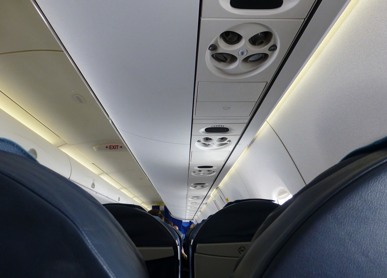 a view of the inside of an airplane, blue theme and yellow accents, usa-sep 20, photo taken in 2018, very sparse detail