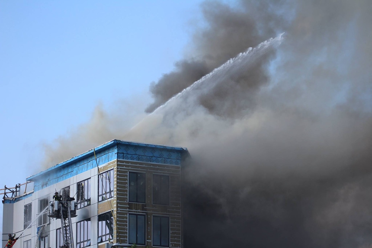 a fire is coming out of the top of a building, photograph credit: ap, breathing blue fire, smoke fills the area, taejune kim