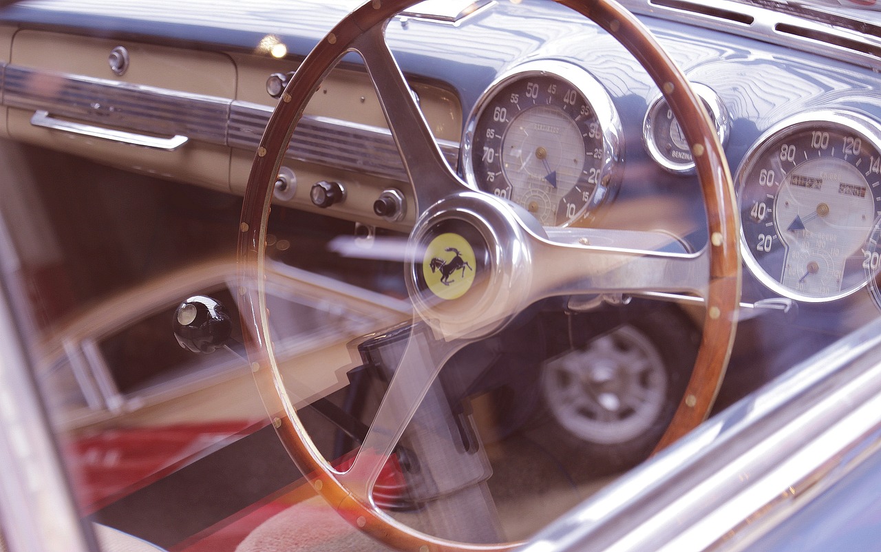 a close up of a steering wheel on a car, a portrait, by Robert Peak, vintage inspired, ferrari, wooden, tilt shift”