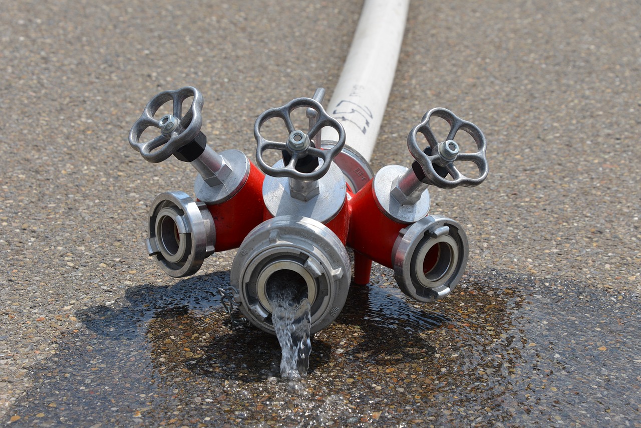 a fire hydrant spewing water out of the ground, a photo, by Kazimierz Wojniakowski, shutterstock, with pipes attached to it, high detail product photo, high detailed close up of, hoses