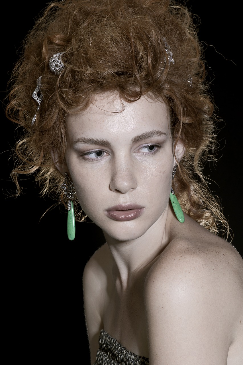 a close up of a woman with red hair, inspired by Jan Lievens, emerald earrings, patrick demarchelier, pale green glow, nadav kander