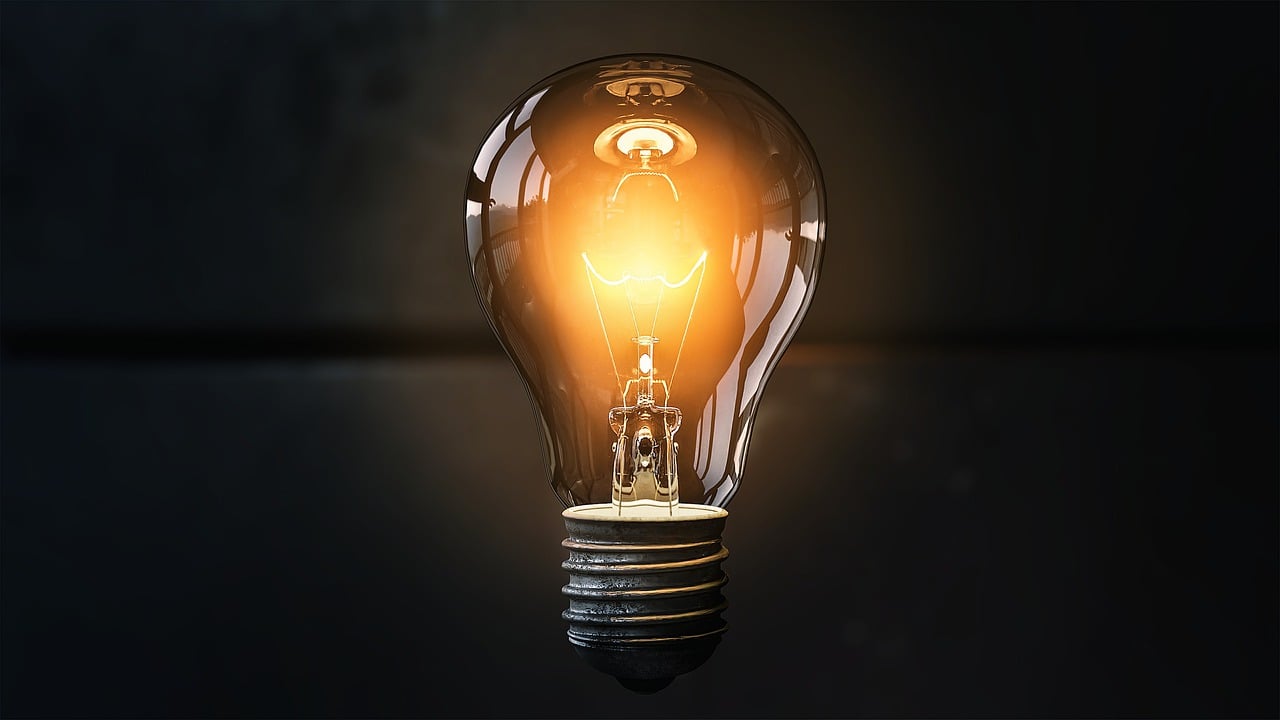 a light bulb sitting on top of a table, a picture, profile pic, lit from below, glowing details!, light source from the left