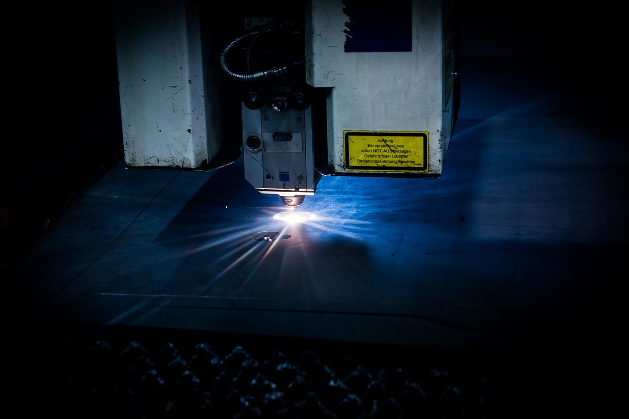 a machine working on a piece of metal, by Matthias Weischer, pexels, holography, laser beam ; outdoor, blades in the dark, full length shot, laquer and steel