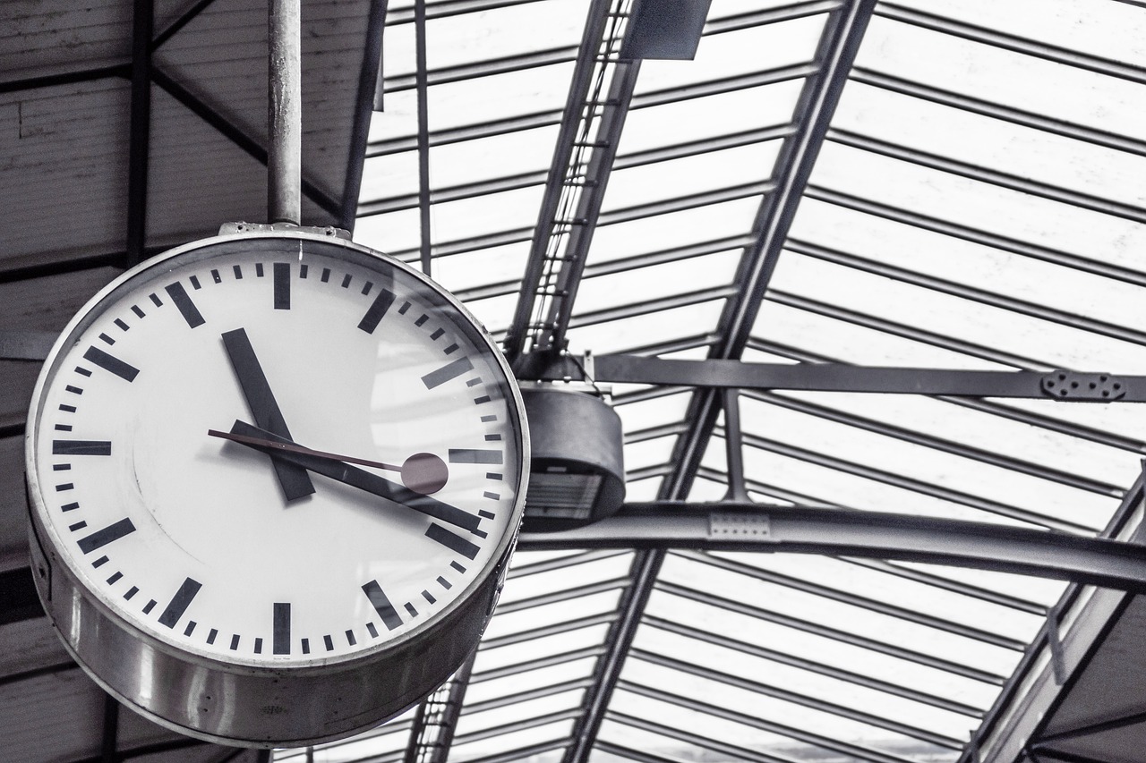 a clock hanging from the ceiling of a train station, a photo, modern very sharp photo, hyper detailed photo, 1128x191 resolution, utrecht