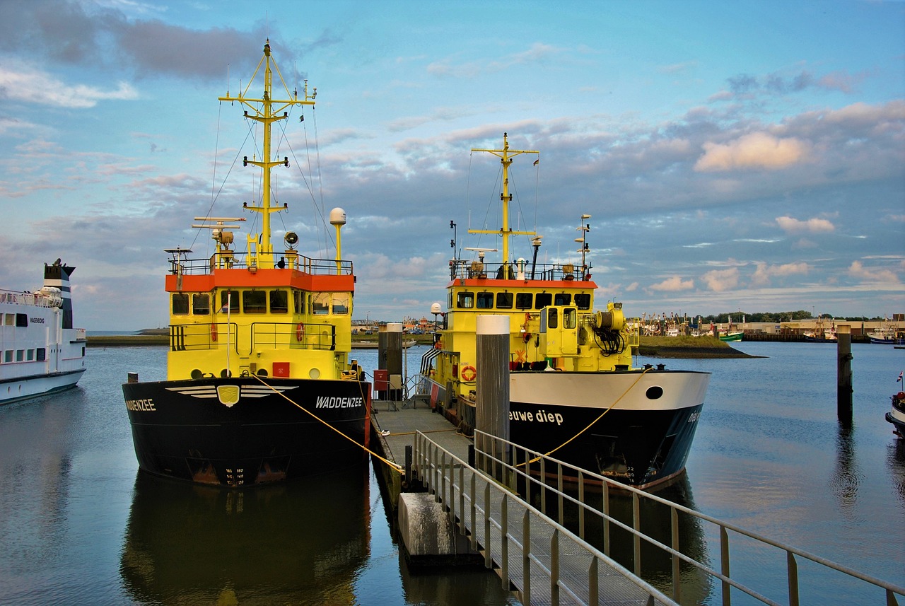 a couple of boats that are sitting in the water, by Richard Carline, flickr, happening, yellow scheme, shipping docks, werecrow, tourist photo