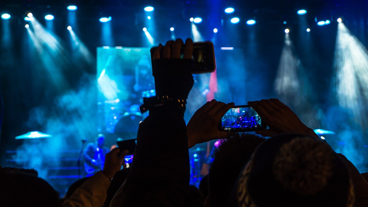 a person taking a picture of a concert with a cell phone, a picture, happening, watch photo, elaborate stage effects, 2 0 2 2 photo, 2 0 1 5 live music video