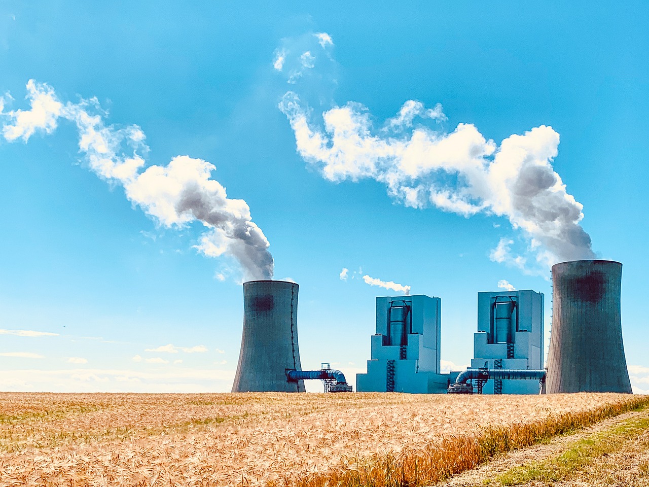 a field that has a bunch of smoke coming out of it, a stock photo, nuclear art, two organic looking towers, large blue engines, sunny summer day, overflowing energy