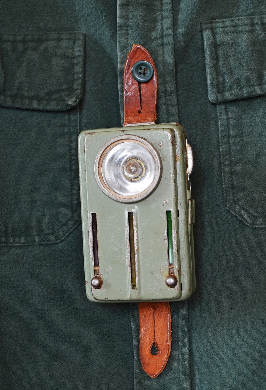 a close up of a belt with a camera attached to it, by Eero Järnefelt, flickr, bauhaus, flashlight, soviet nostalgia, a green, close up shot of an amulet