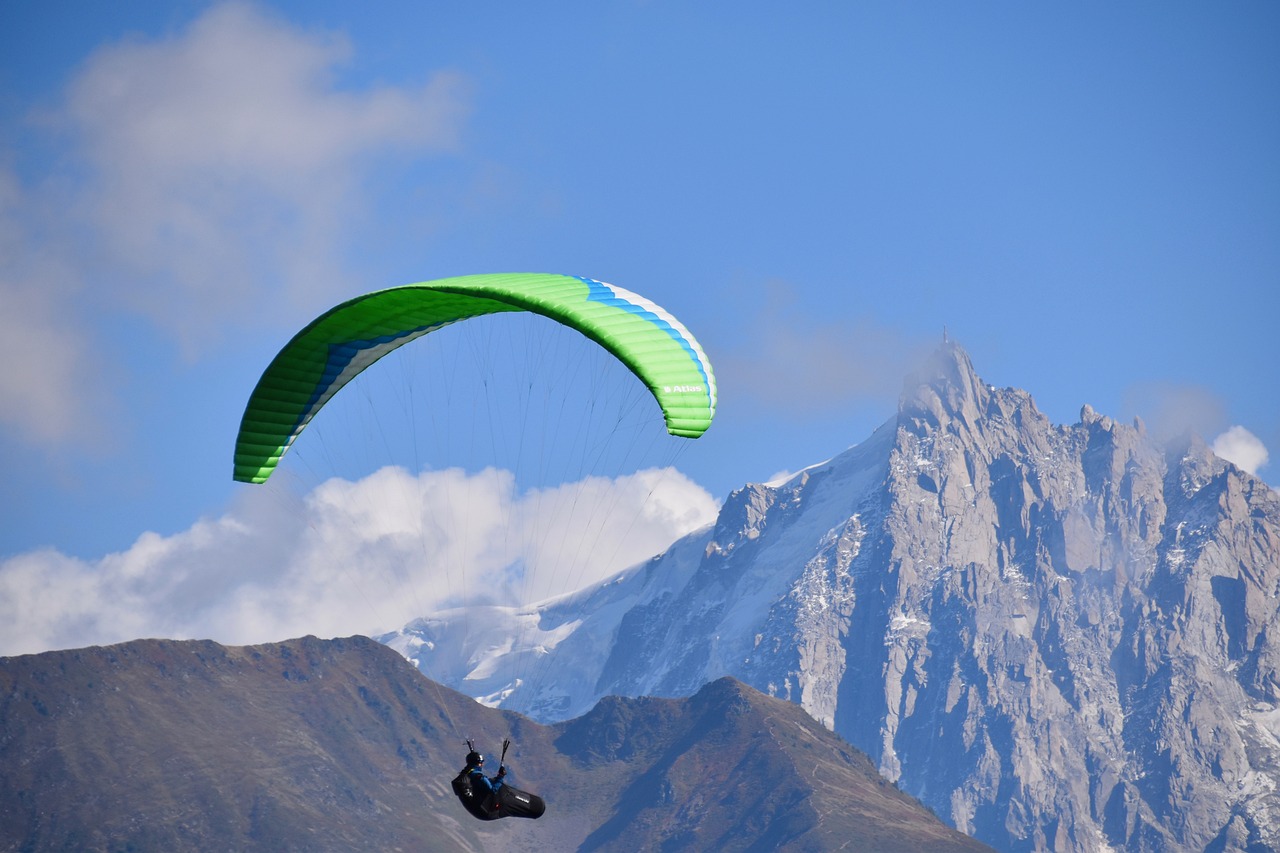 a person parasailing with a mountain in the background, a picture, by Werner Andermatt, shutterstock, green and blue color scheme, siberia!!, flying vehicles, wallpaper - 1 0 2 4
