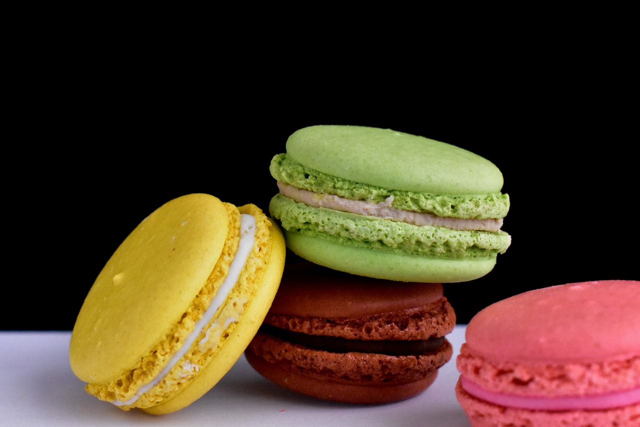 a pile of macarons sitting on top of a table, inspired by François Louis Thomas Francia, pexels, pop art, on black background, loputyn and matcha, full of colour 8-w 1024, detail