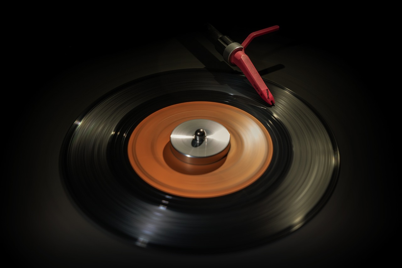 a close up of a record with a red handle, photorealism, long exposure photo, seventies, tool, high quality product photo