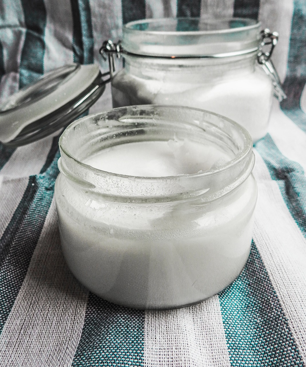 a couple of jars sitting on top of a table, pixabay, process art, cotton texture, white powder makeup, trimmed with a white stripe, milk - bath effect