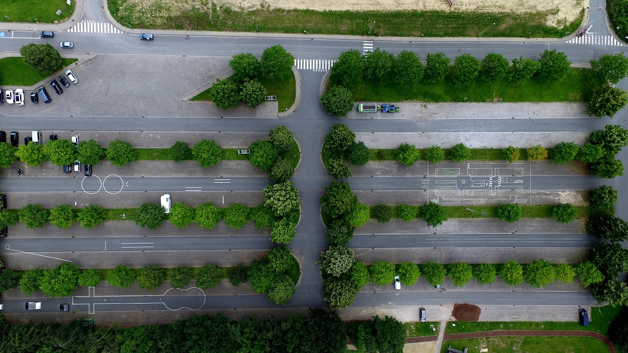 a bird's eye view of a city street, a picture, by Oskar Lüthy, ((trees)), parking lot, green lines, hedge