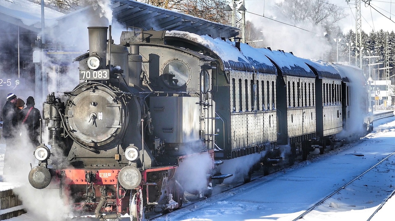 a train traveling down train tracks covered in snow, by Jörg Immendorff, trending on pixabay, art nouveau, brass and steam technology, in karuizawa, a steam wheeler from 1880s, black