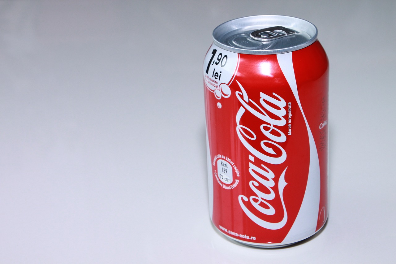 a can of coca cola sitting on a table, a picture, by Almada Negreiros, shutterstock, half body photo, on grey background, stock photo, sao paulo