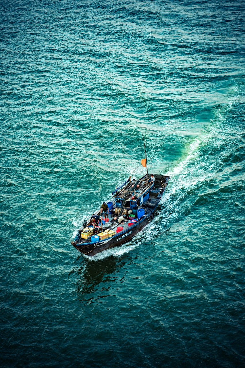 a boat filled with people riding on top of a body of water, a tilt shift photo, shutterstock, hashima island, tourist photo, pirates, news photo