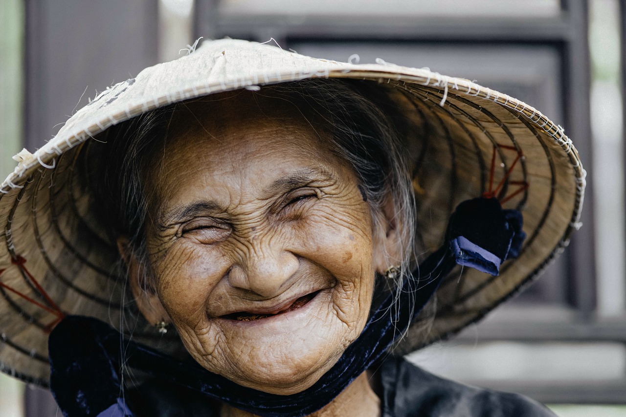 a close up of a person wearing a hat, pexels contest winner, mingei, so happy that her face hurts, vietnamese woman, wrinkled big cheeks, avatar image