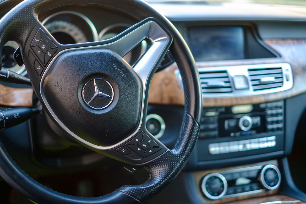 a close up of a steering wheel in a car, by Matthias Weischer, les automatistes, mercedez benz, istock, high detail shot, beautiful surroundings