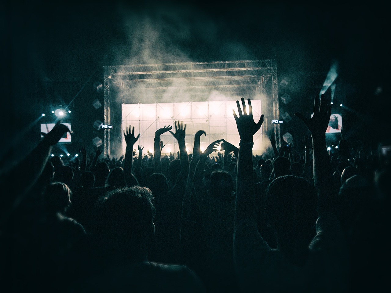 a crowd of people at a concert with their hands in the air, a picture, moody hazy lighting, billboard image, spooky photo, discovered photo